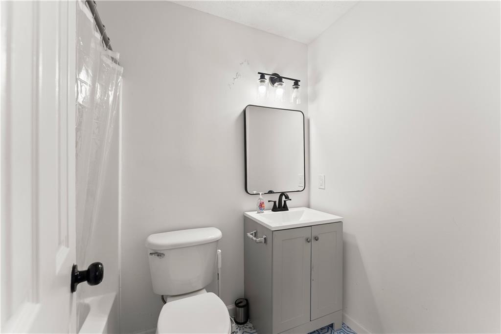 322 Wyngate Road Auburn, GA 30011 - Photo 23 of 44 a bathroom with a toilet sink and mirror