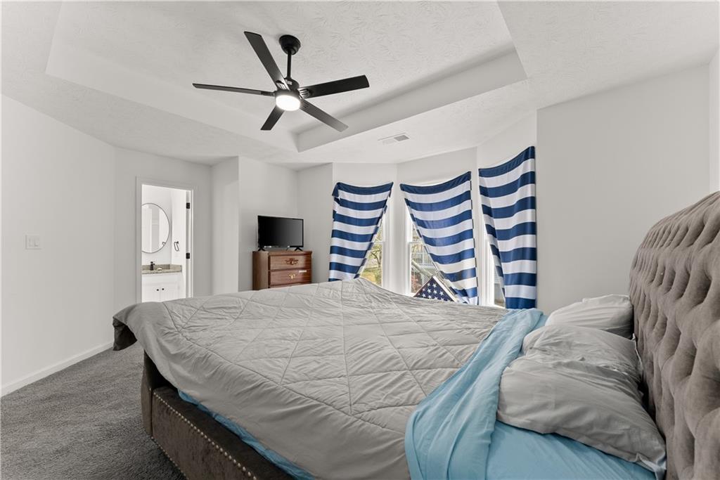 322 Wyngate Road Auburn, GA 30011 - Photo 25 of 44 a bedroom with a bed and a flat screen tv