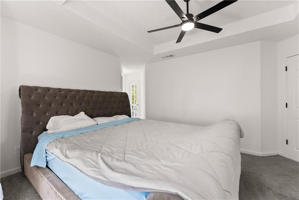 322 Wyngate Road Auburn, GA 30011 - Photo 26 of 44 a bedroom with a bed and a ceiling fan