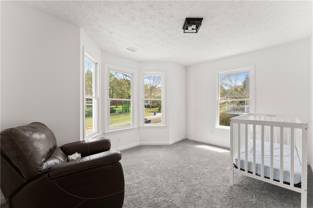 322 Wyngate Road Auburn, GA 30011 - Photo 31 of 44 a living room with furniture and a window