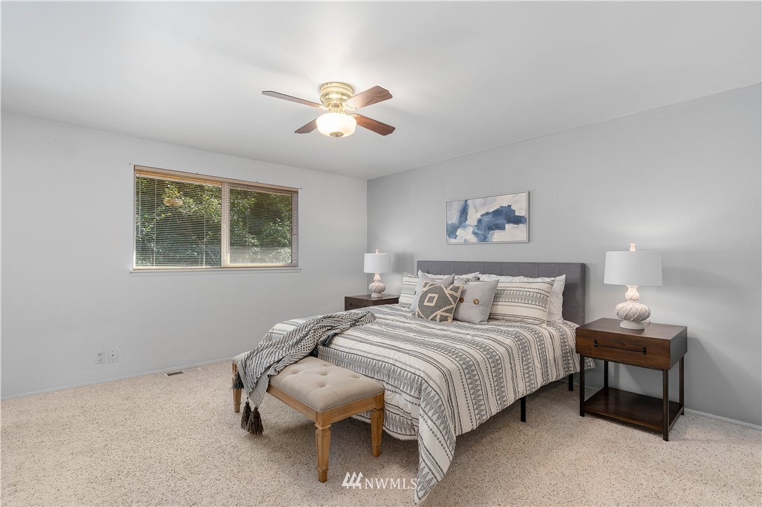 924 217th Street Southwest Bothell, WA 98021 - Photo 16 of 30 a bedroom with a bed and a chandelier