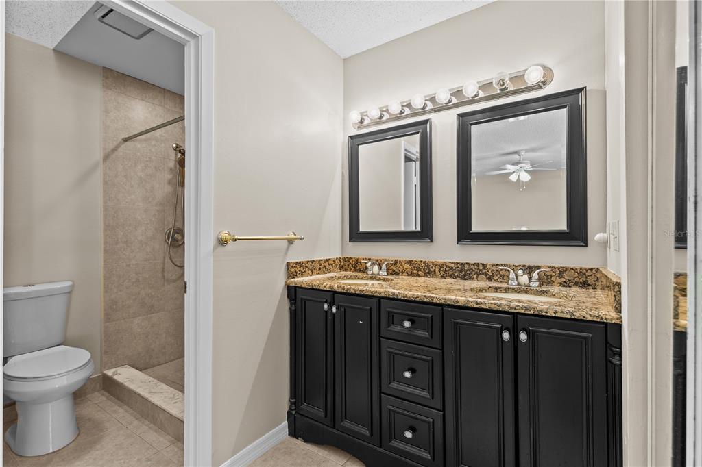 111 Feather Edge Loop, Unit 4B Lake Mary, FL 32746 - Photo 13 of 27 a bathroom with a toilet sink and mirror