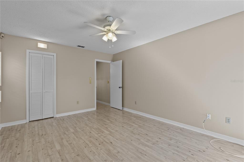 111 Feather Edge Loop, Unit 4B Lake Mary, FL 32746 - Photo 16 of 27 a view of an empty room with wooden floor