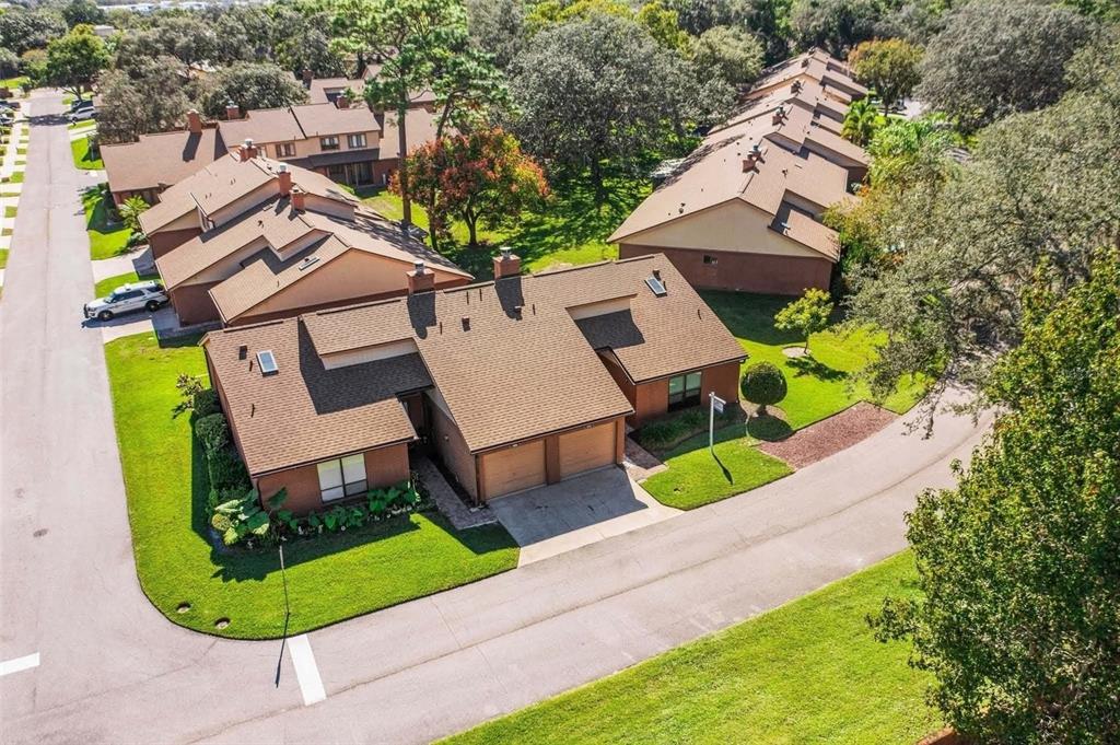 111 Feather Edge Loop, Unit 4B Lake Mary, FL 32746 - Photo 19 of 27 an aerial view of a house with a garden and trees