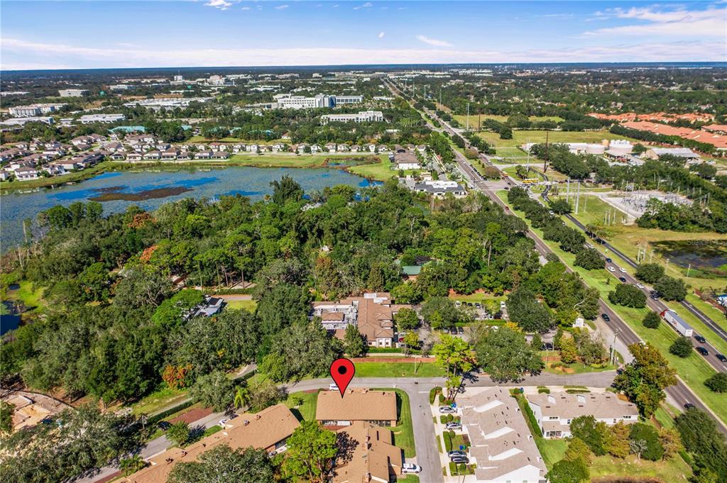 111 Feather Edge Loop, Unit 4B Lake Mary, FL 32746 - Photo 22 of 27 an aerial view of residential building and lake