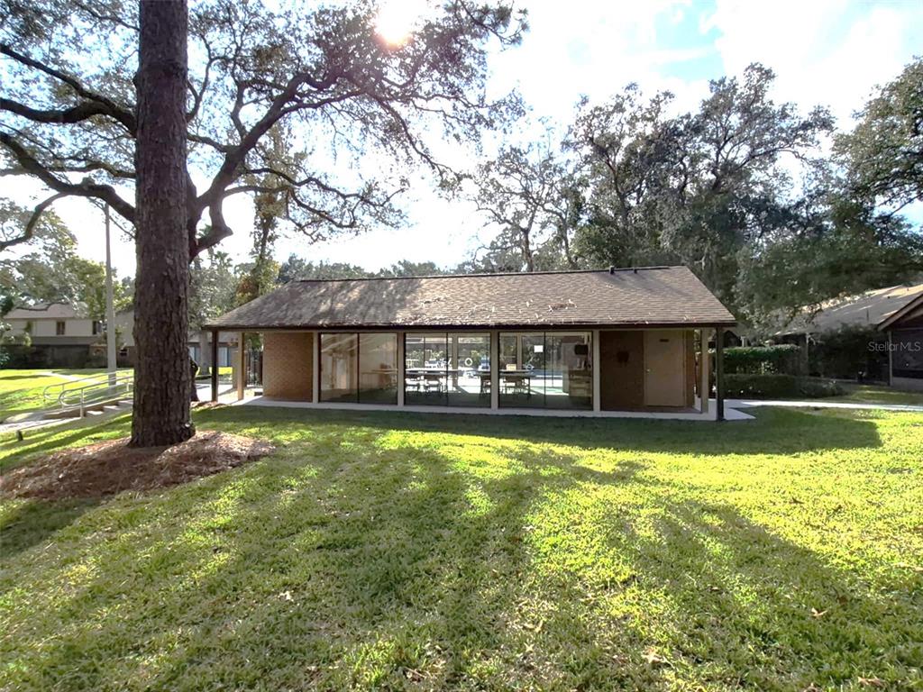 111 Feather Edge Loop, Unit 4B Lake Mary, FL 32746 - Photo 27 of 27 a front view of a house with swimming pool next to a big yard