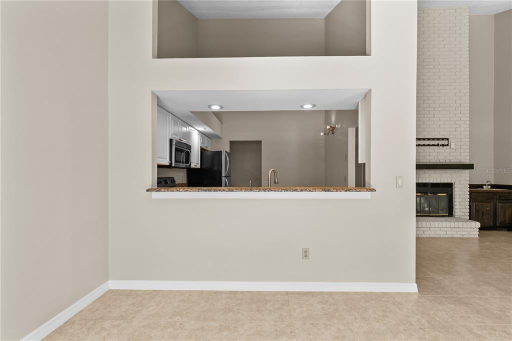 111 Feather Edge Loop, Unit 4B Lake Mary, FL 32746 - Photo 5 of 27 a view of a kitchen with a hallway