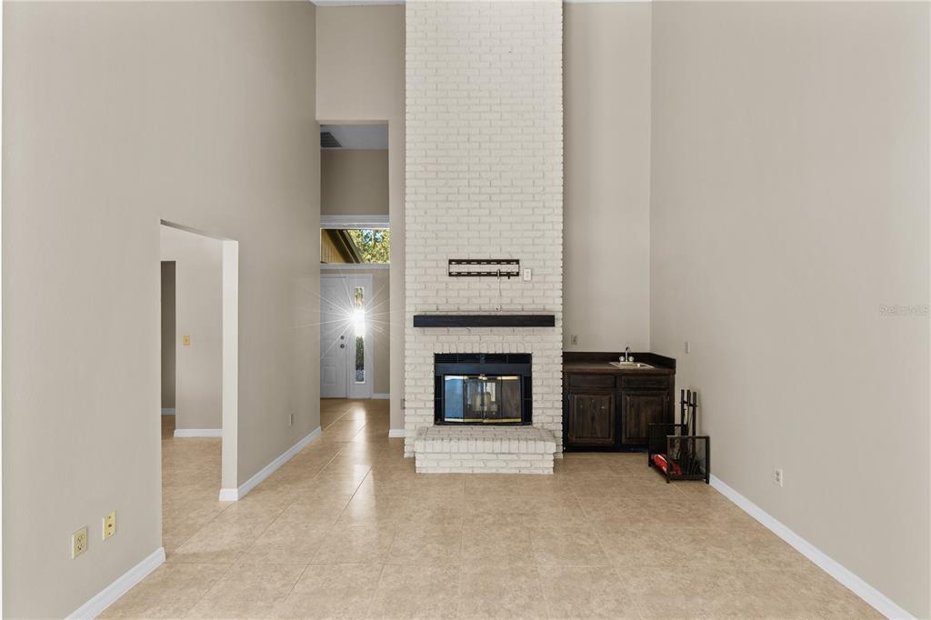 111 Feather Edge Loop, Unit 4B Lake Mary, FL 32746 - Photo 8 of 27 an empty room with fireplace and cabinet