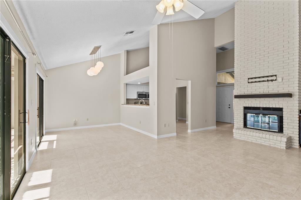 111 Feather Edge Loop, Unit 4B Lake Mary, FL 32746 - Photo 10 of 27 an empty room with windows and fireplace