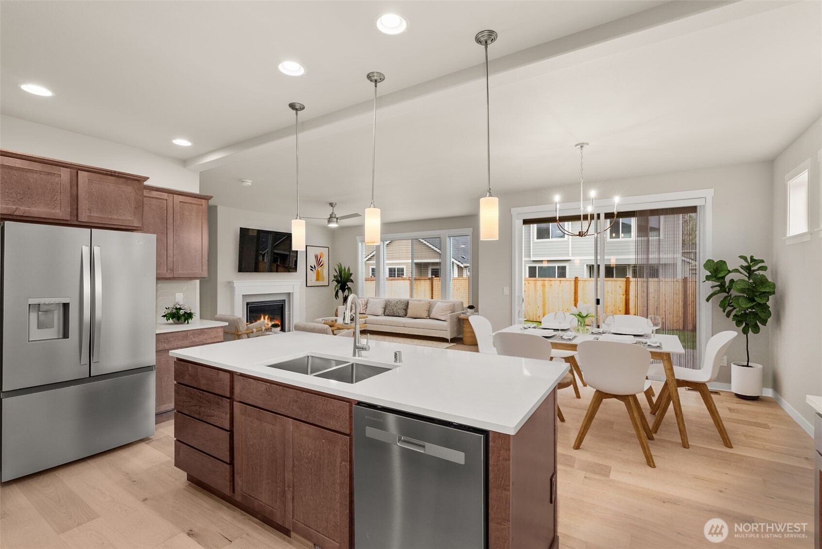 7308 Jenner Street Southwest Tumwater, WA 98512 - Photo 11 of 40 a kitchen with a sink a refrigerator and chairs