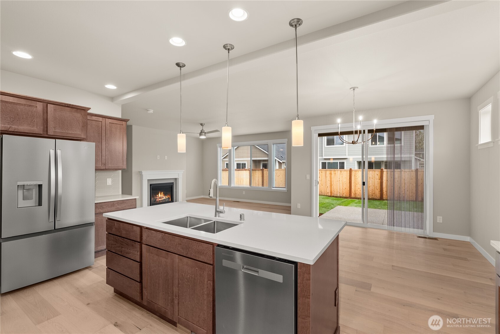 7308 Jenner Street Southwest Tumwater, WA 98512 - Photo 13 of 34 a kitchen with a sink refrigerator and cabinets
