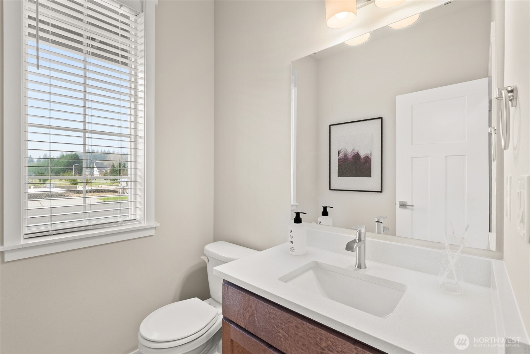 7308 Jenner Street Southwest Tumwater, WA 98512 - Photo 13 of 40 a bathroom with a sink toilet and mirror