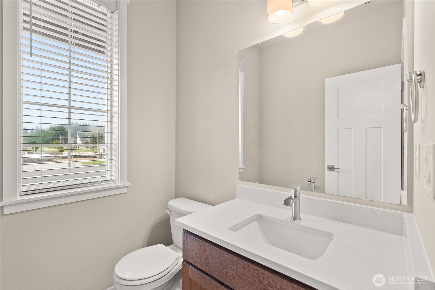 7308 Jenner Street Southwest Tumwater, WA 98512 - Photo 15 of 34 a bathroom with a sink toilet and window
