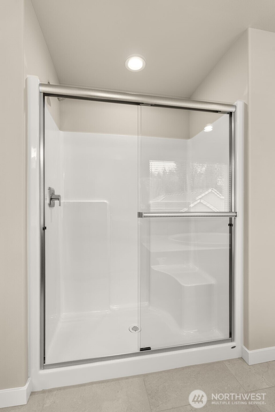 7308 Jenner Street Southwest Tumwater, WA 98512 - Photo 20 of 40 a bathroom with a glass shower door