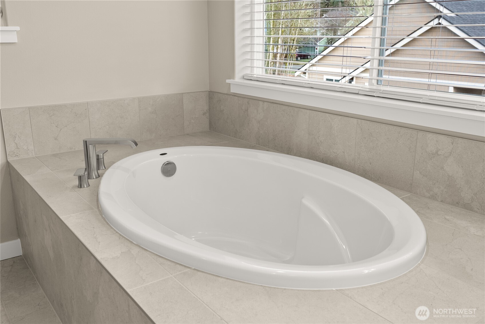 7308 Jenner Street Southwest Tumwater, WA 98512 - Photo 21 of 34 a white bath tub sitting in a bathroom