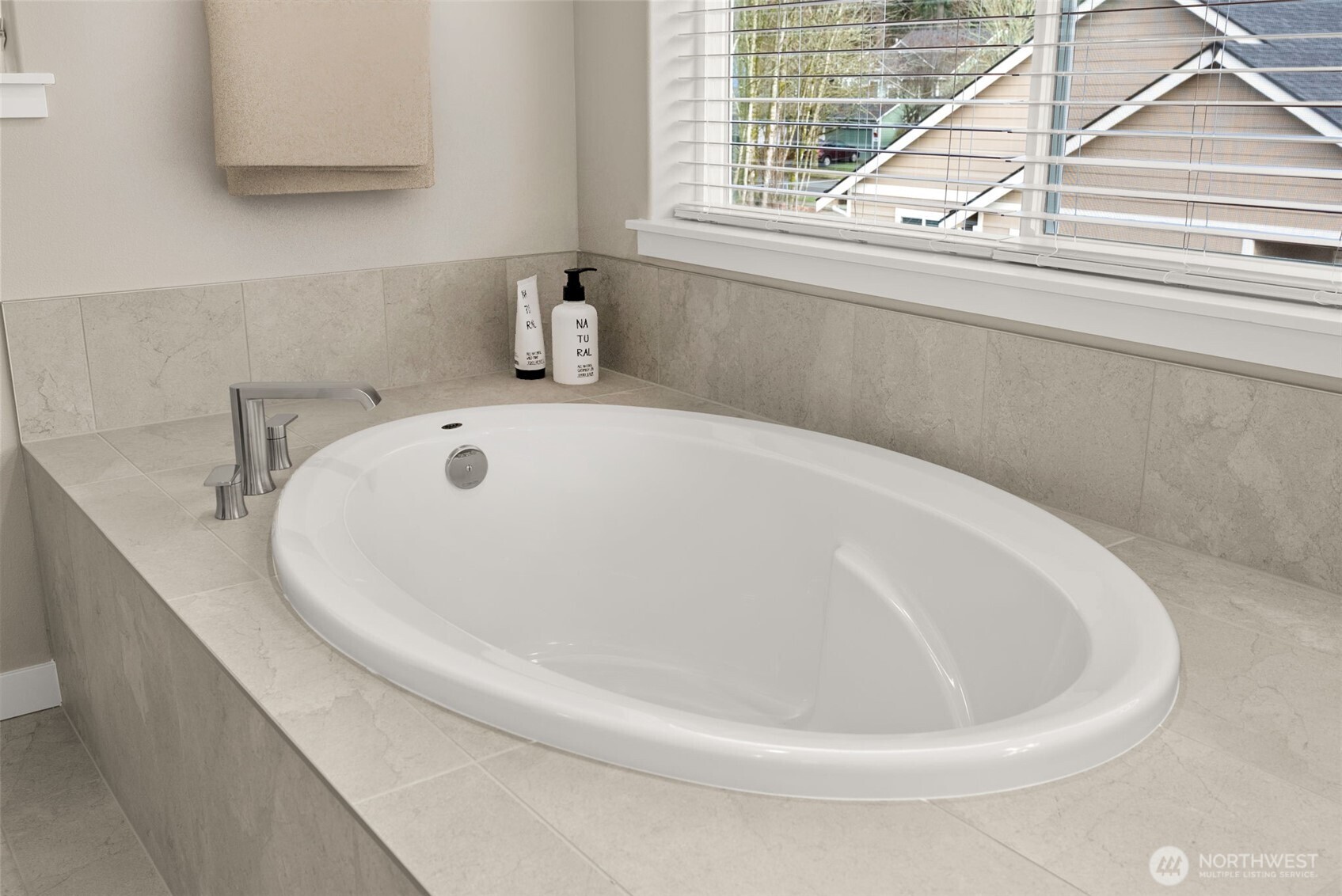 7308 Jenner Street Southwest Tumwater, WA 98512 - Photo 21 of 40 a white bath tub sitting in a bathroom