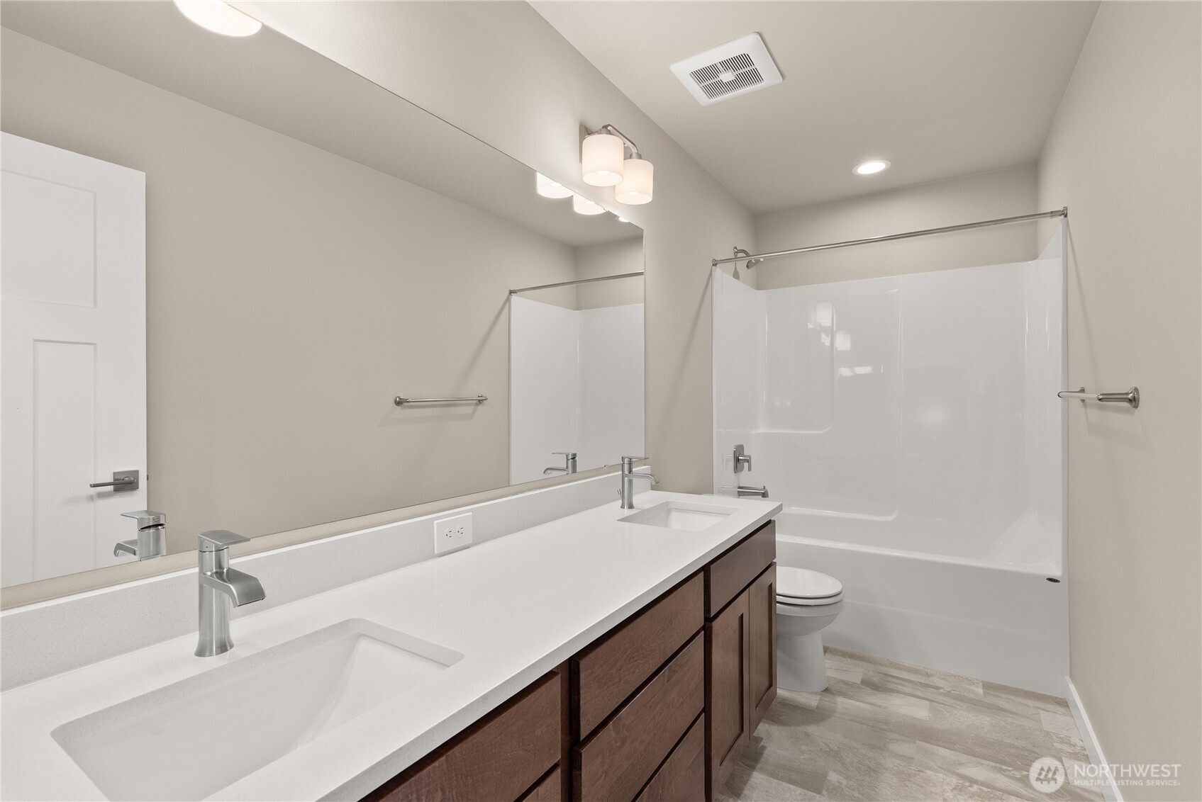 7308 Jenner Street Southwest Tumwater, WA 98512 - Photo 23 of 34 a bathroom with a sink a toilet a mirror and shower