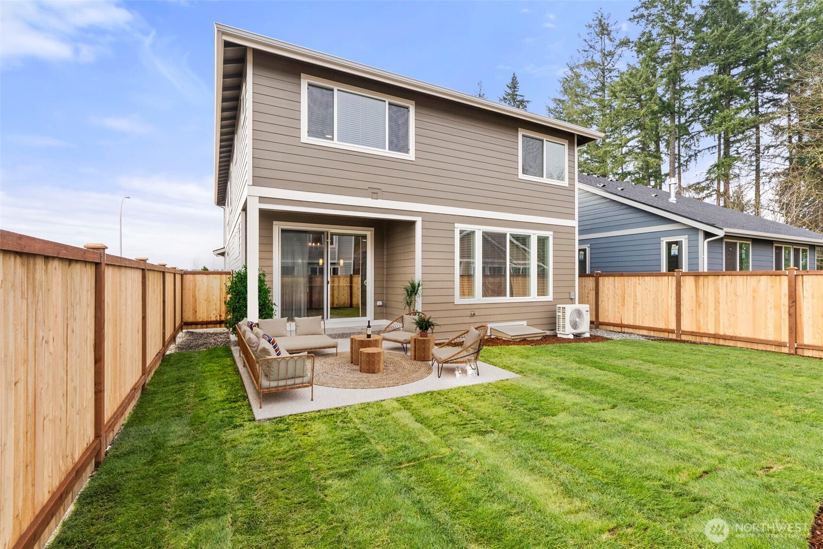 7308 Jenner Street Southwest Tumwater, WA 98512 - Photo 30 of 40 a view of a house with backyard sitting area and garden