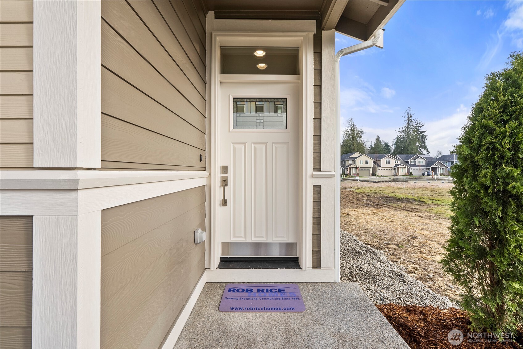 7308 Jenner Street Southwest Tumwater, WA 98512 - Photo 3 of 34 a front view of a house with a yard