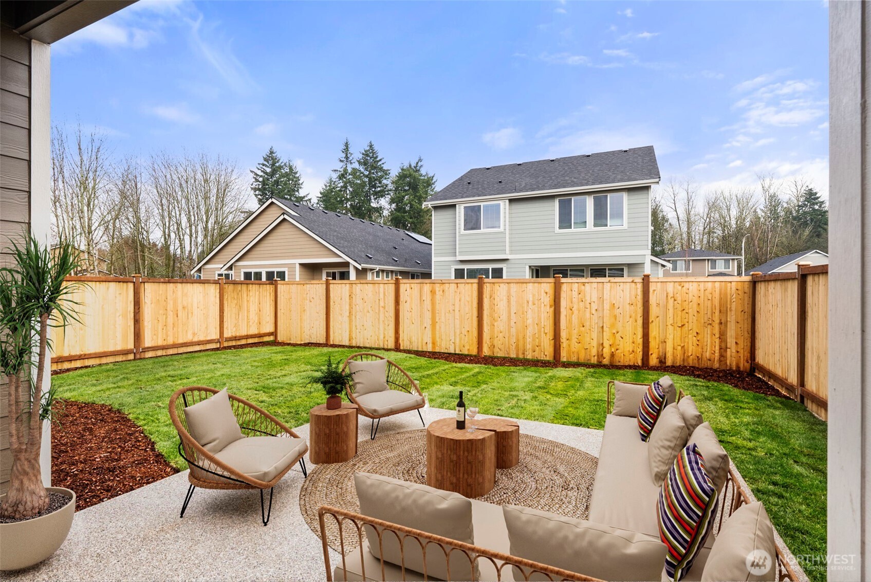 7308 Jenner Street Southwest Tumwater, WA 98512 - Photo 32 of 40 a view of a patio with couches chairs potted plants and a yard