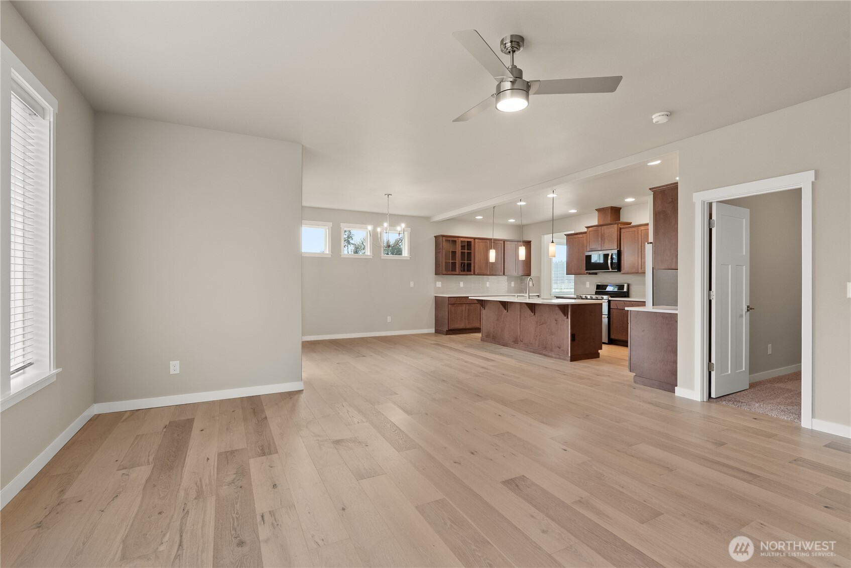 7308 Jenner Street Southwest Tumwater, WA 98512 - Photo 6 of 34 a view of kitchen with refrigerator stove and wooden floor