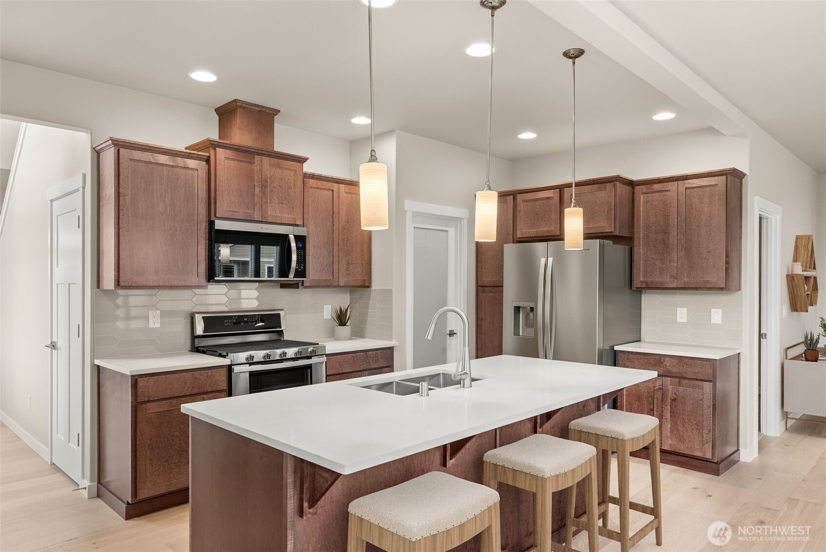 7308 Jenner Street Southwest Tumwater, WA 98512 - Photo 7 of 40 a kitchen with stainless steel appliances kitchen island granite countertop a kitchen island a stove a table and chairs