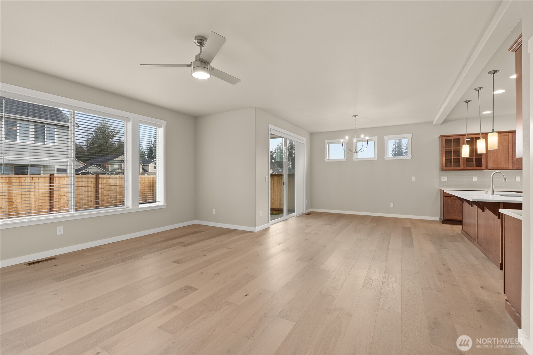 7308 Jenner Street Southwest Tumwater, WA 98512 - Photo 7 of 34 a view of an empty room with a window and wooden floor