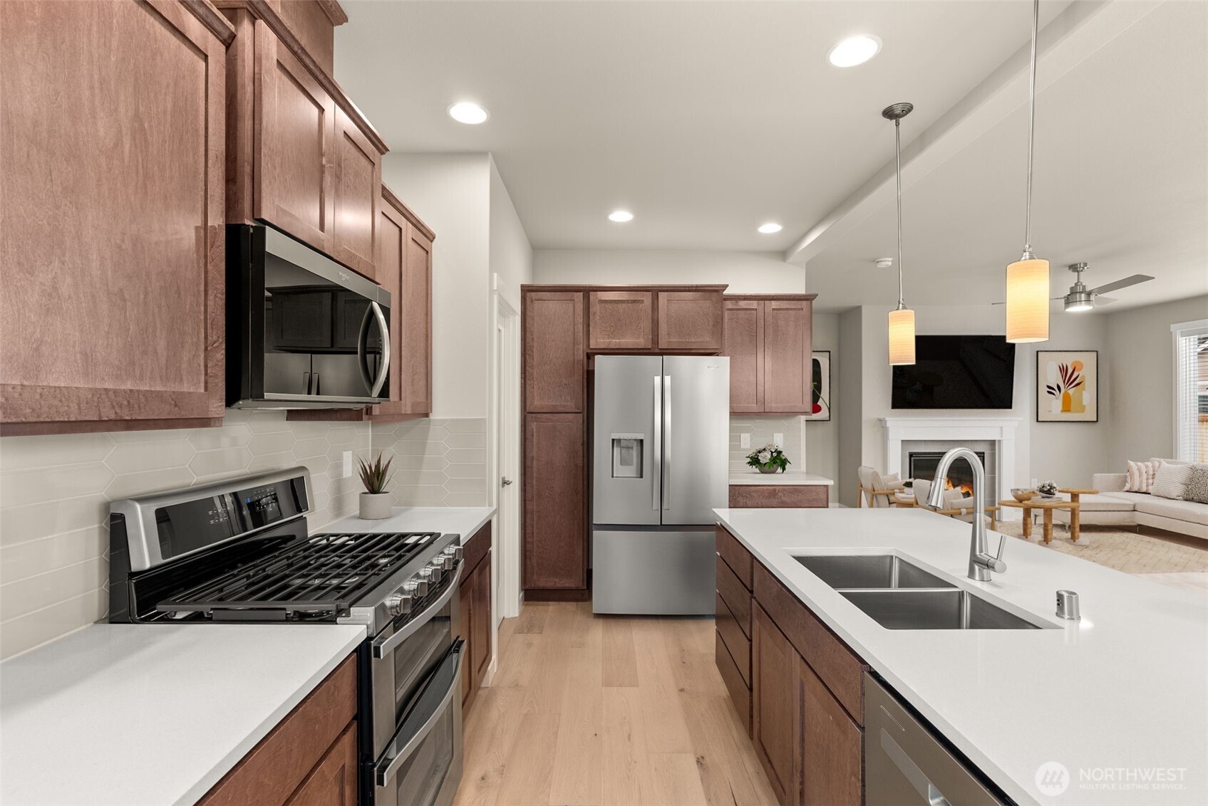 7308 Jenner Street Southwest Tumwater, WA 98512 - Photo 8 of 40 a kitchen with refrigerator a sink and a microwave
