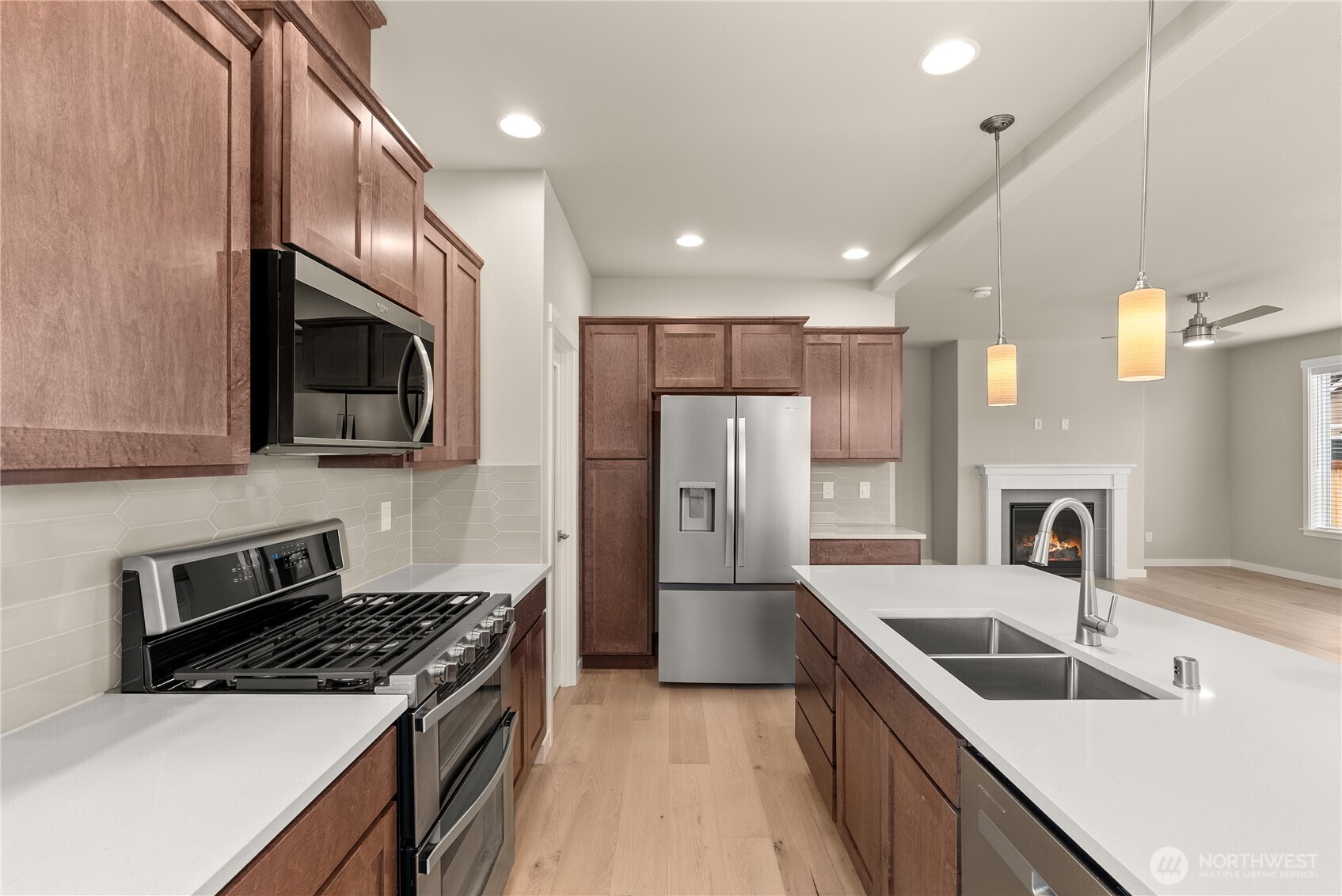 7308 Jenner Street Southwest Tumwater, WA 98512 - Photo 10 of 34 a kitchen with refrigerator a sink and a microwave