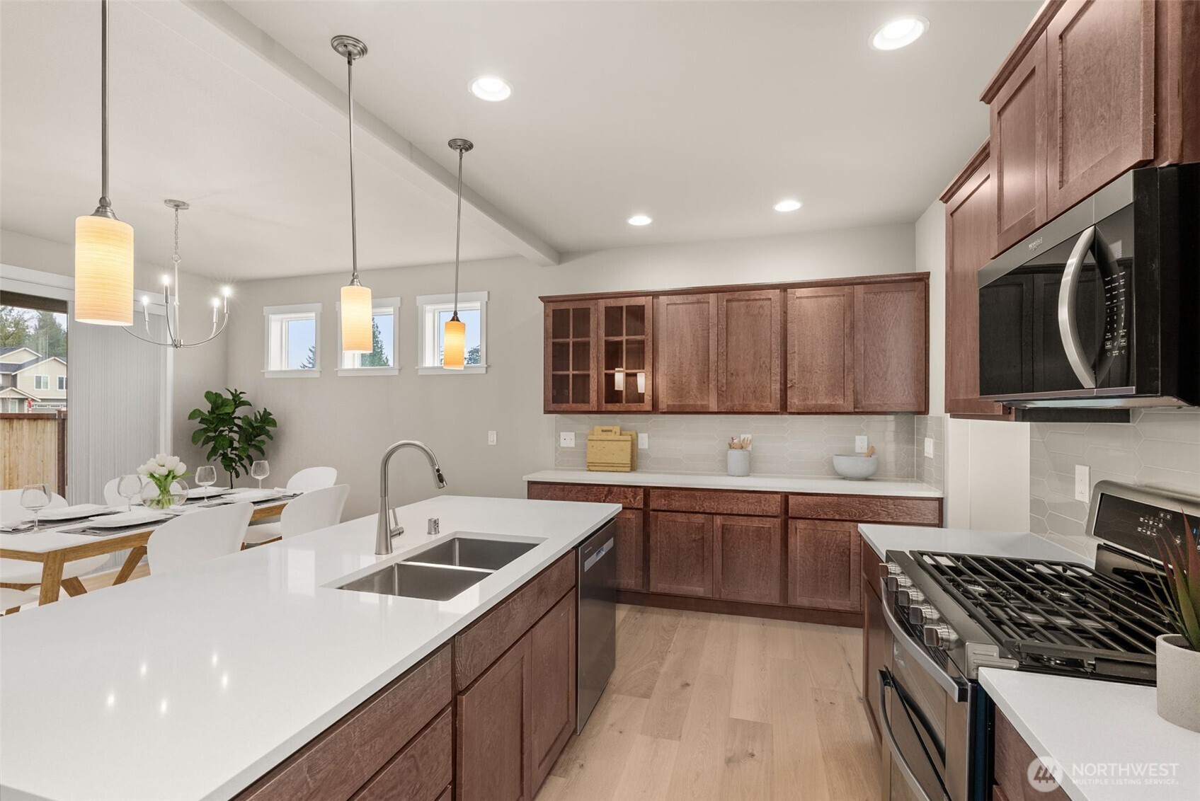 7308 Jenner Street Southwest Tumwater, WA 98512 - Photo 10 of 40 a kitchen that has a sink and a stove in it