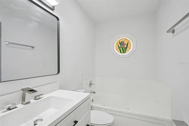 a bathroom with a sink a mirror and shower