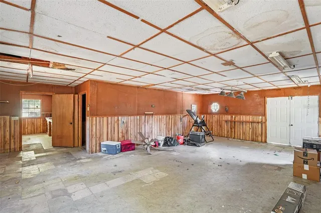 a view of a kitchen with wooden walls