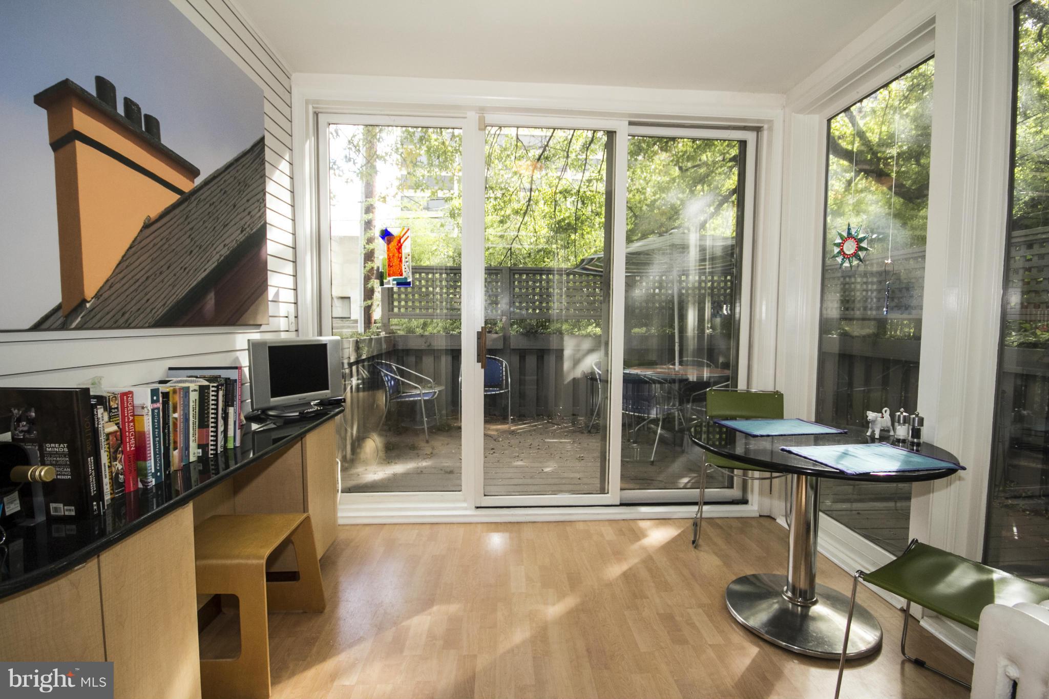 3957 Cloverhill Road Baltimore, MD 21218 - Photo 14 of 30 a dining room with furniture and a floor to ceiling window