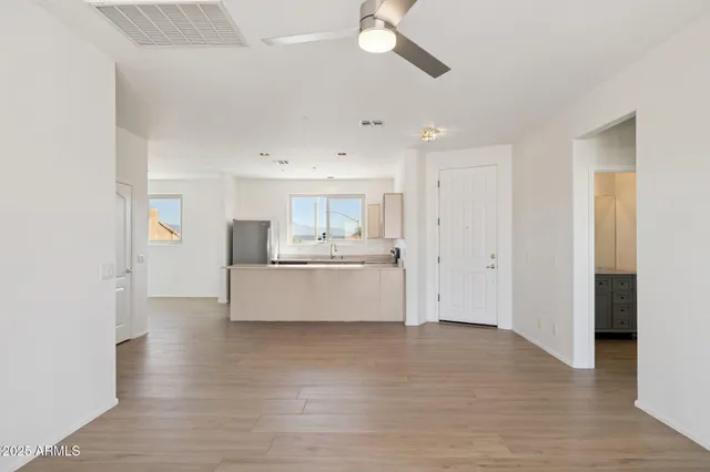 a kitchen with a sink a table and chairs in it