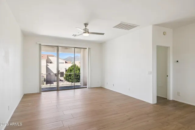 a kitchen with granite countertop a stove and white cabinets