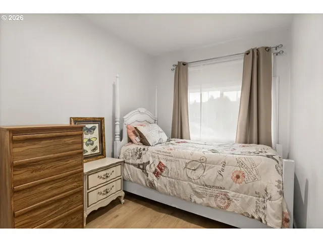 a bed sitting in a bedroom next to a window