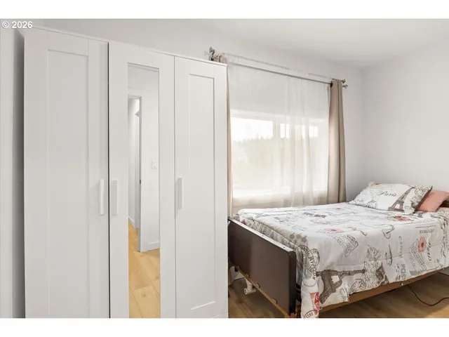 a bedroom with a bed and a table