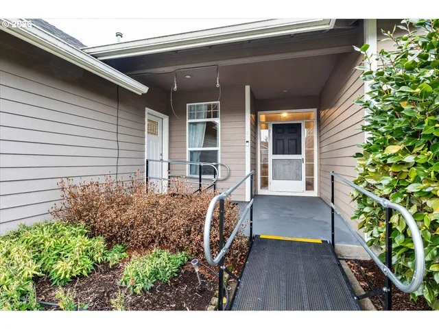 a view of house with backyard and sitting area