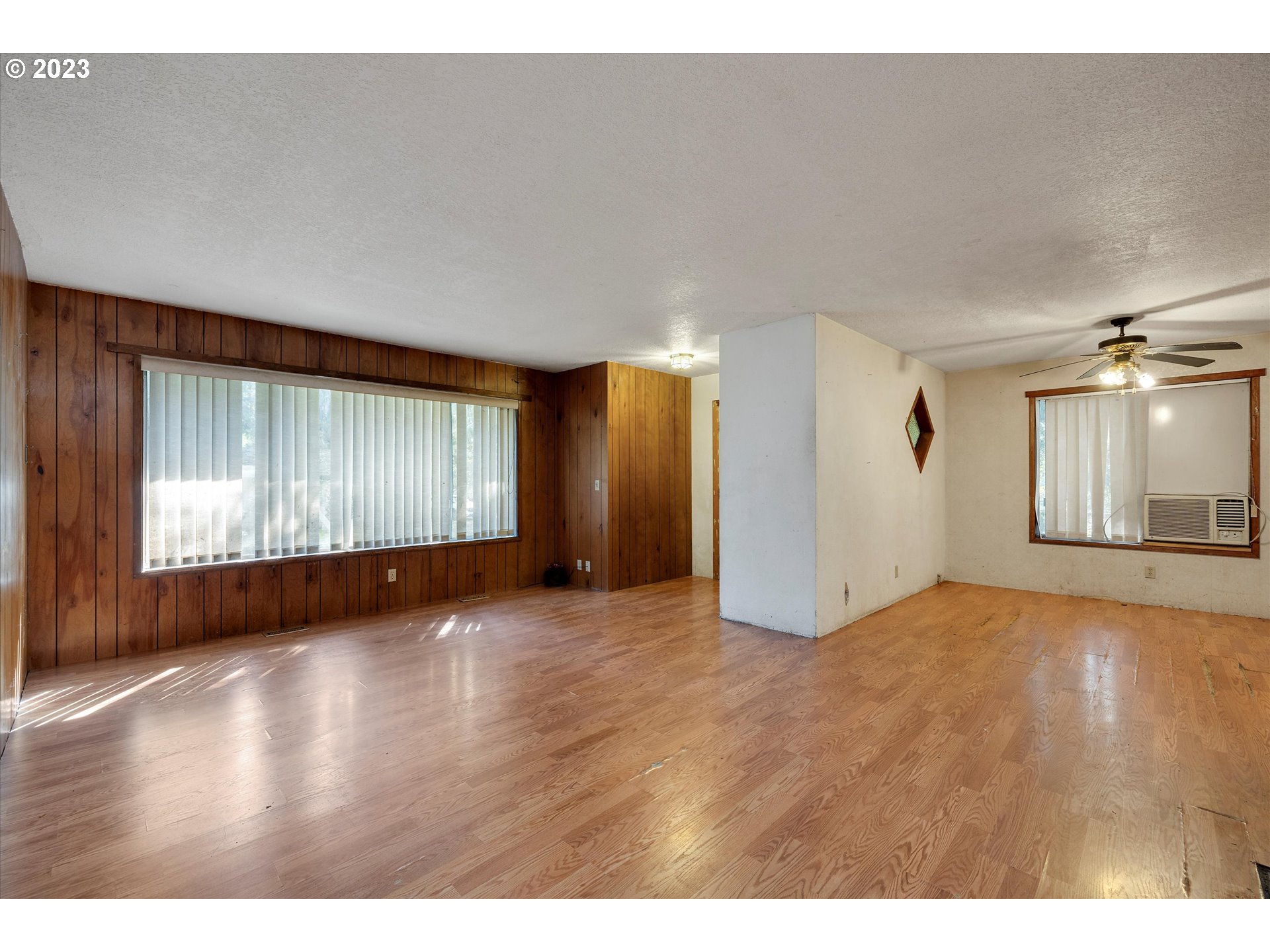 495 Southwest Grove Road Estacada, OR 97023 - Photo 6 of 39 a view of an empty room with wooden floor and windows