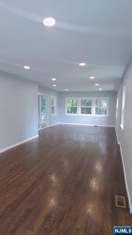 a backyard of a house with lots of trees and plants