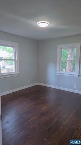 a view of a house with a yard and large tree
