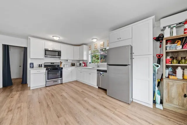 a kitchen with stainless steel appliances a refrigerator stove and microwave