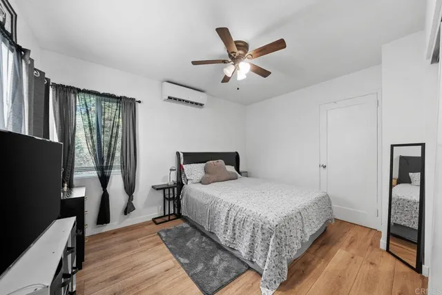 a bedroom with a bed and a desk