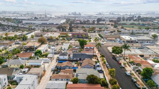 an aerial view of residential houses with outdoor space and parking
