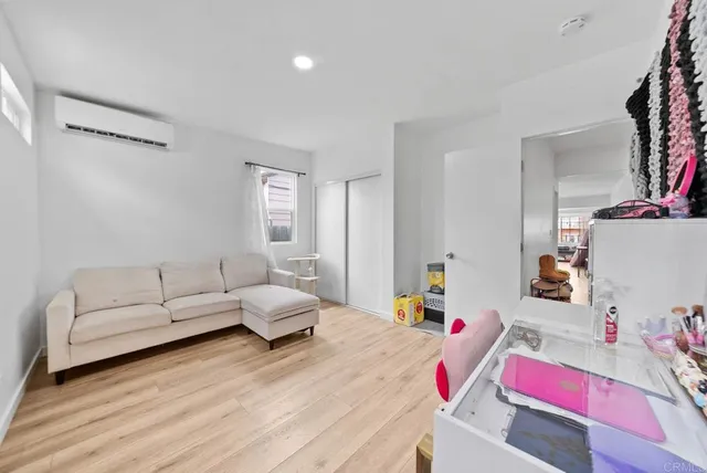 a living room with furniture and a wooden floor