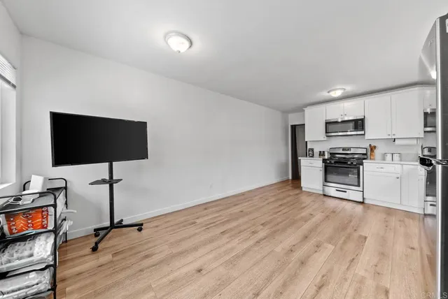 a kitchen with stainless steel appliances a stove a sink and a refrigerator