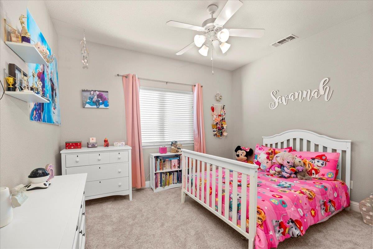 1725 Stonum Road Modesto, CA 95351 - Photo 21 of 34 a bedroom with baby bed and a window