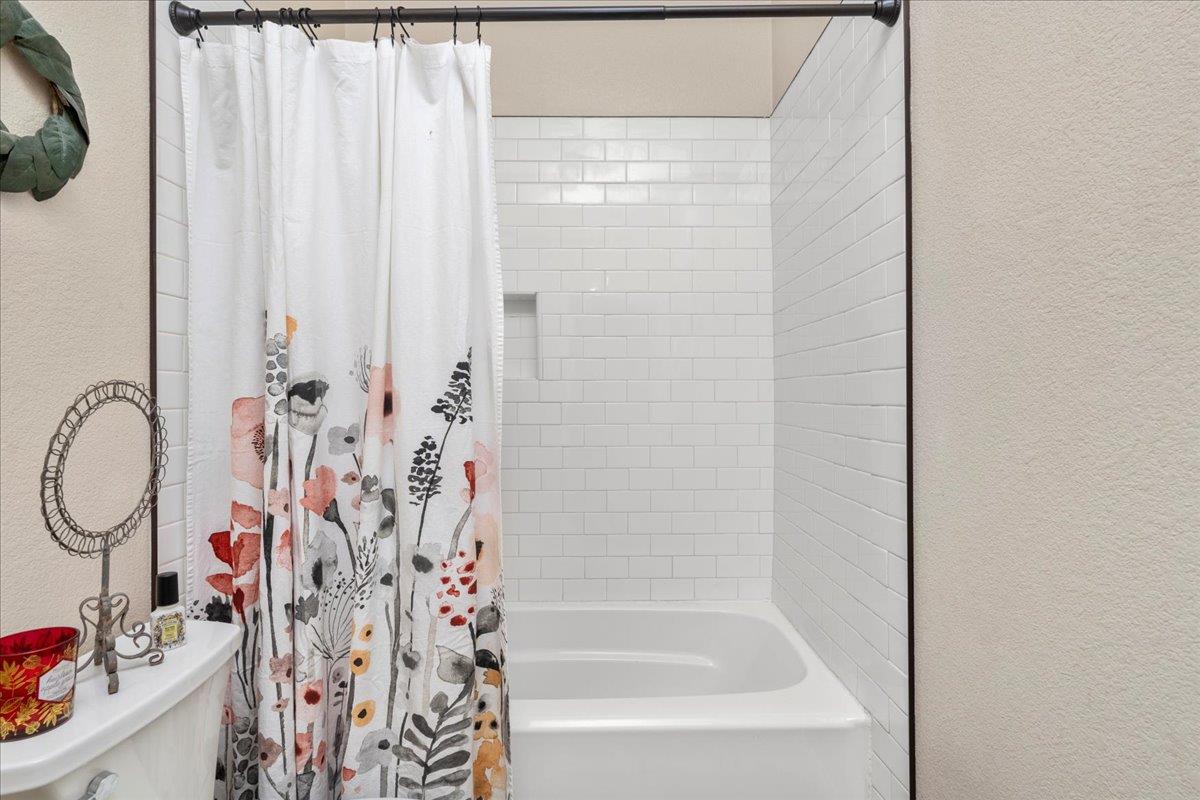 1725 Stonum Road Modesto, CA 95351 - Photo 23 of 34 a bathroom with a bathtub and shower