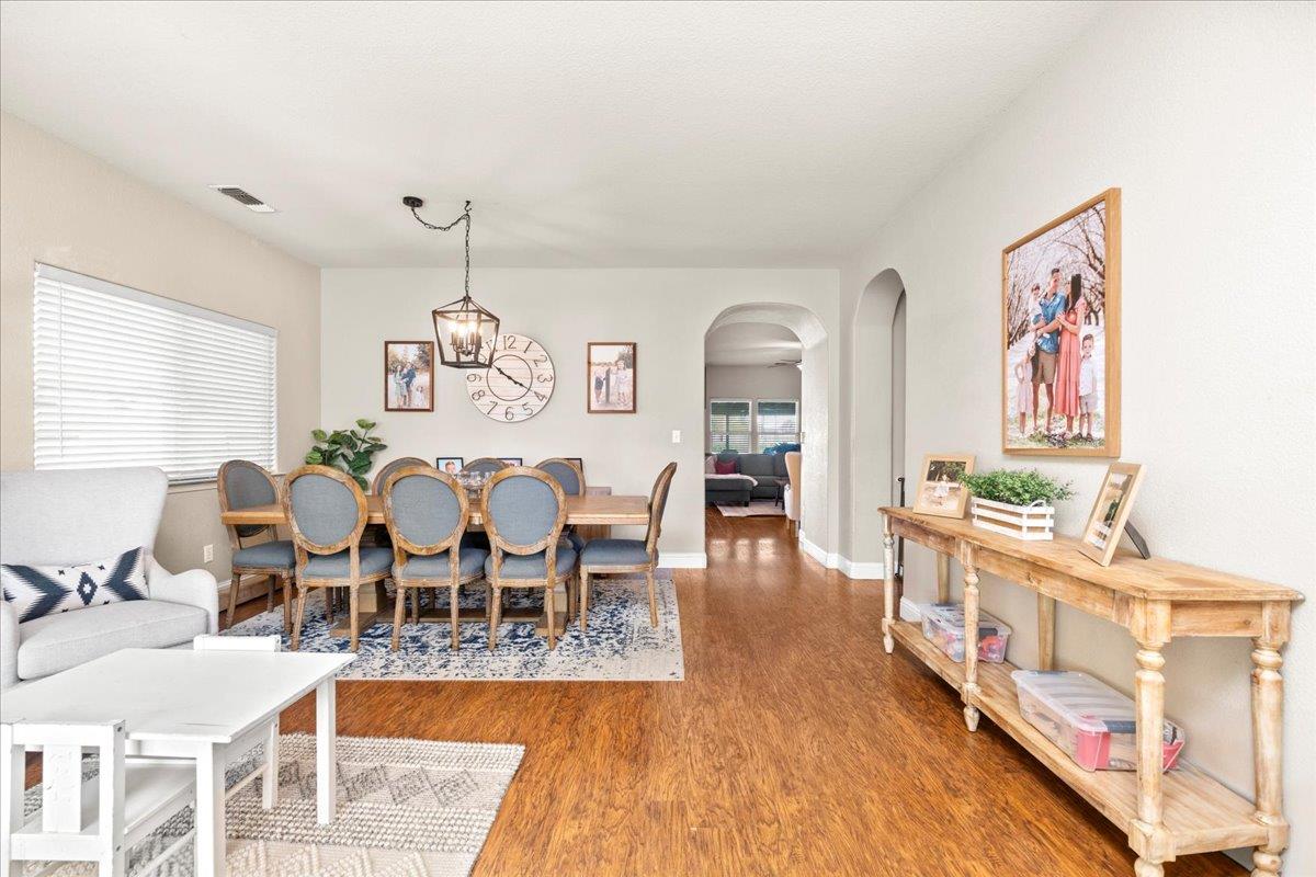 1725 Stonum Road Modesto, CA 95351 - Photo 6 of 34 a view of a dining room with furniture window and wooden floor