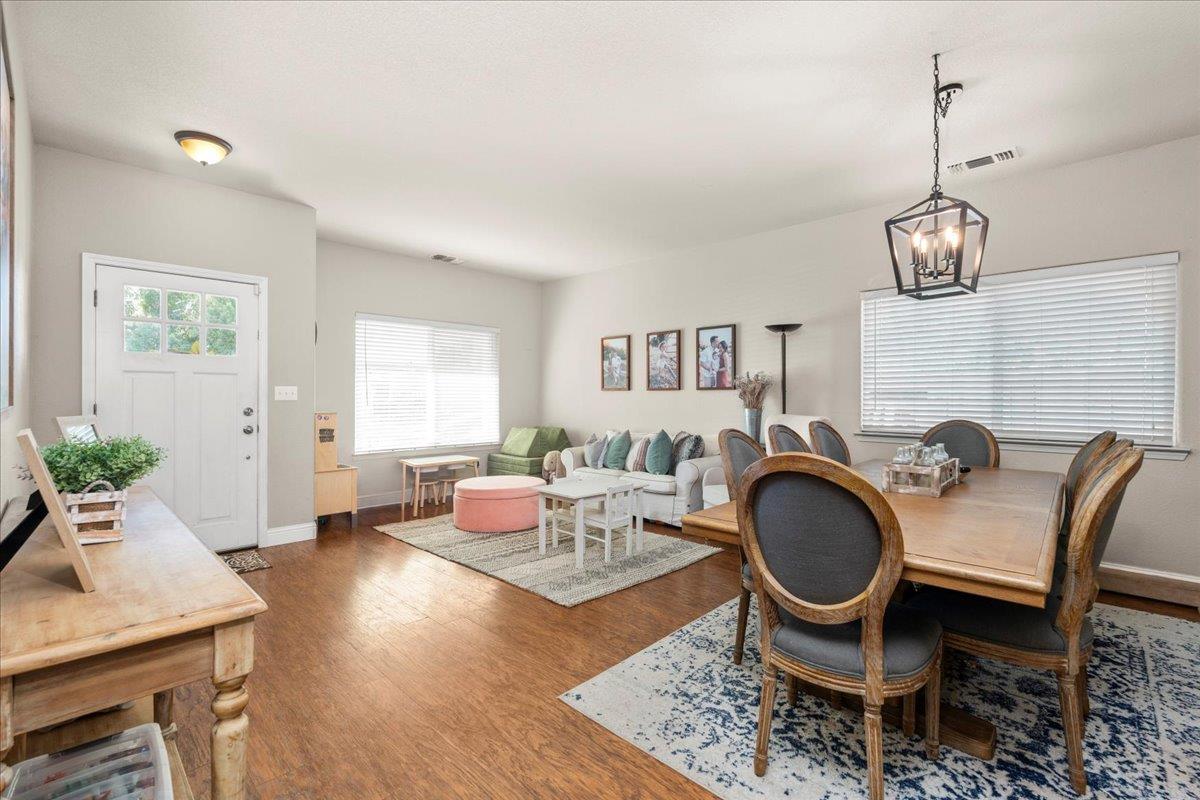 1725 Stonum Road Modesto, CA 95351 - Photo 7 of 34 a living room with furniture a dining table and a chandelier
